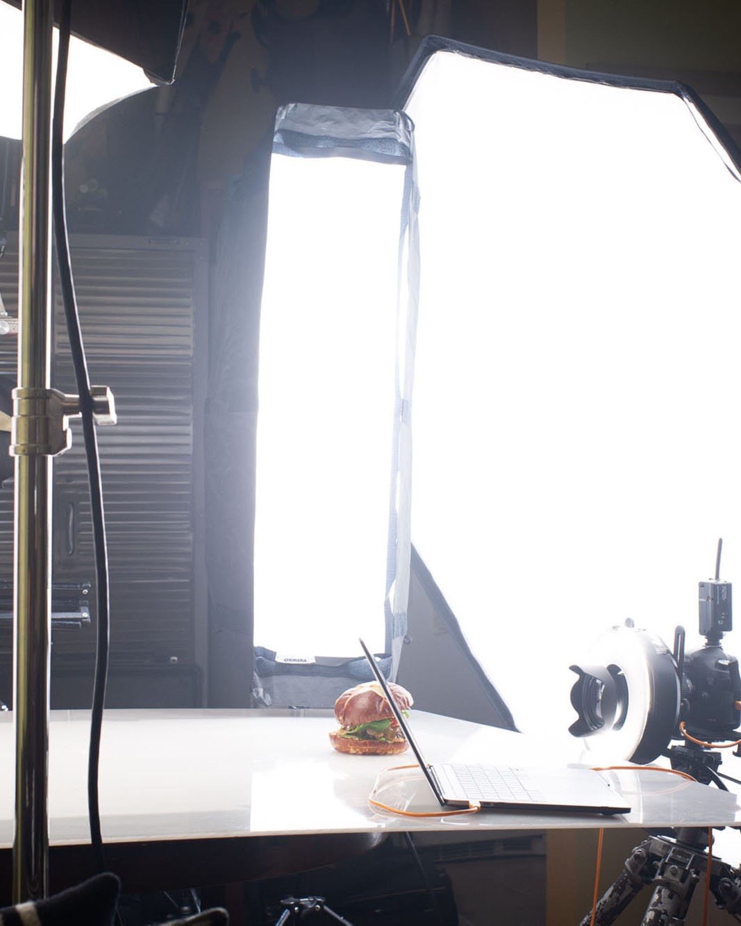 Behind the scenes of a burger being photographed in a photo studio