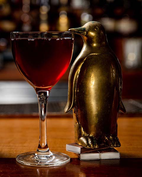 Penguine statue sneaking a drink.