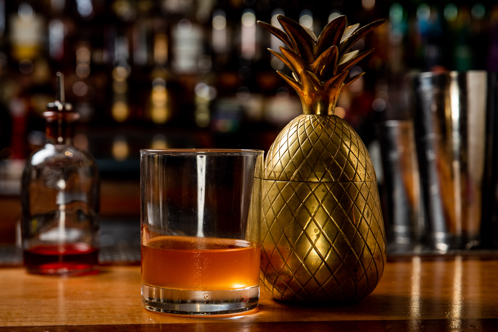 Old Fashioned next to a pineapple weight