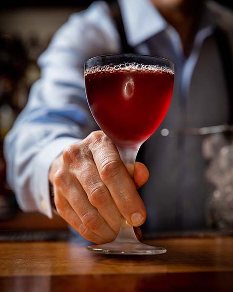 Bartender serving a drink.