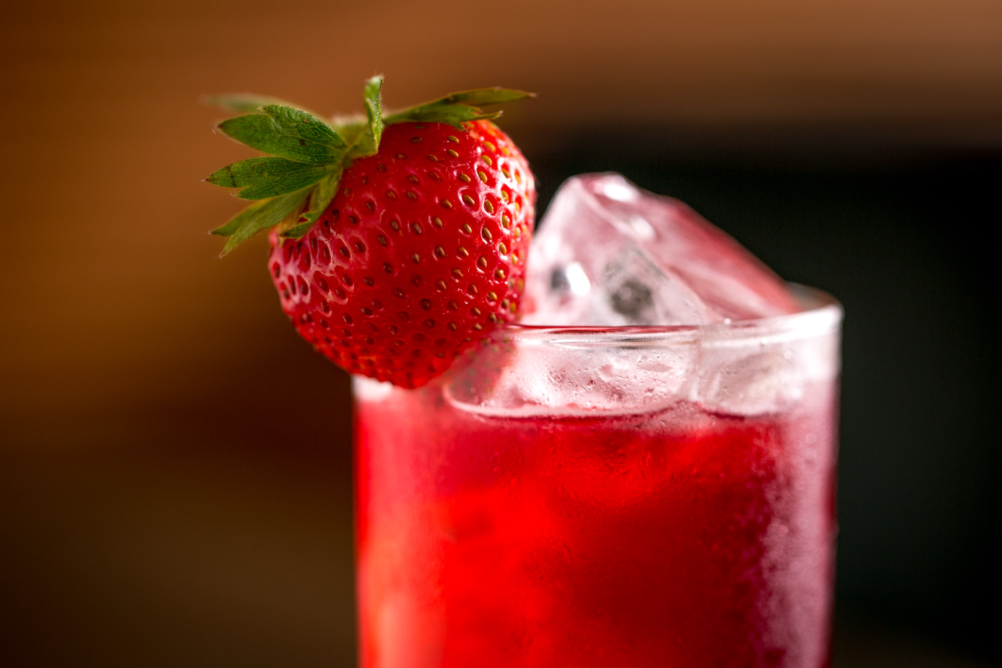 a strawberry garnished drink